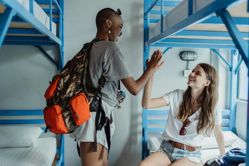 Women High Fiving in a Dorm Room with Bunk Beds 
